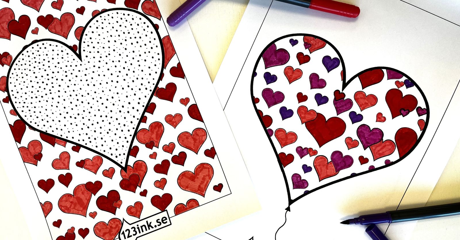 Två hjärtformade målarbilder med färgpennor i rött, lila och svart runtom